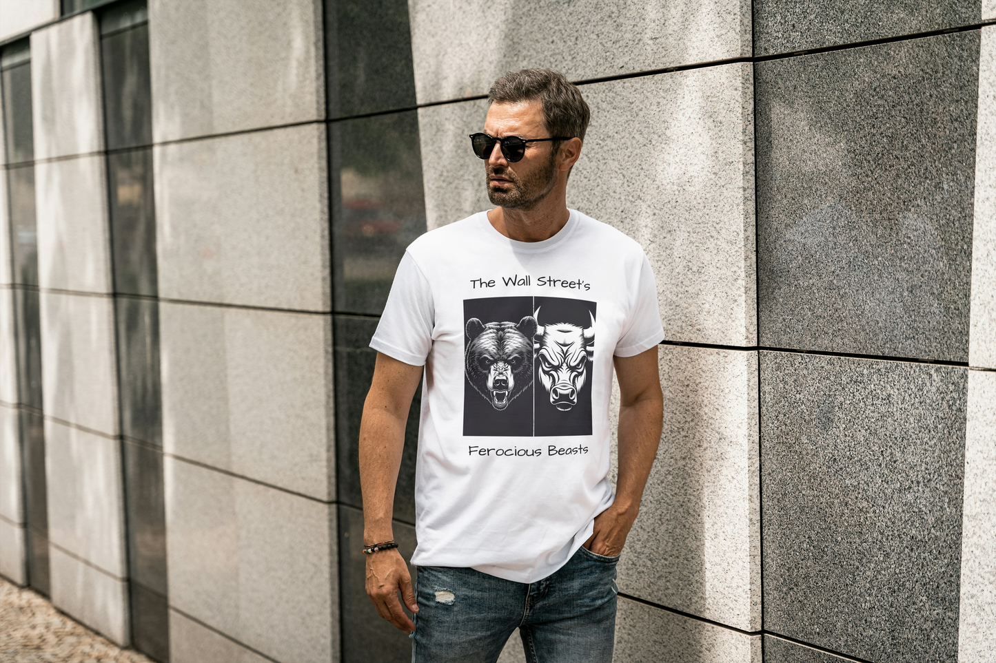 A man wearing a white t-shirt with graphic design of a bear's face side by side with a bull's face with  text that reads The Wall Street ferocious beasts.