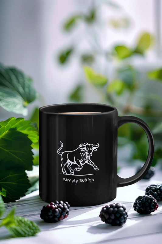 A black ceramic coffee mug with a white bull design and text that reads Simply Bullish.
